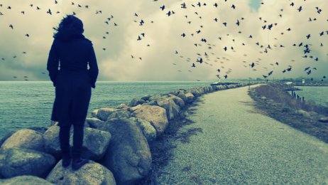 Bildet viser en kvinne som ser ut over havet Bildet viser en kvinne som ser ut over havet