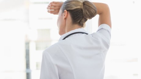 Bildet viser en kvinne som virker sliten og som ser ut av vinduet