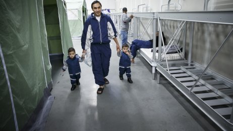 flyktninger, ankomstmottak, Råde Bildet viser Gulam Sarwar og tvillingsønnene som går langs en rad med køyesenger på ankomstmottaket i Råde.