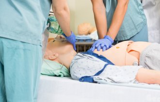 Bildet viser helsepersonell som simulererer hjerte–lunge-redning på en dukke