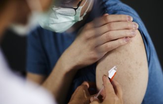 Bildet viser en kvinne som blir vaksinert