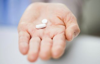 To tabletter i en hånd