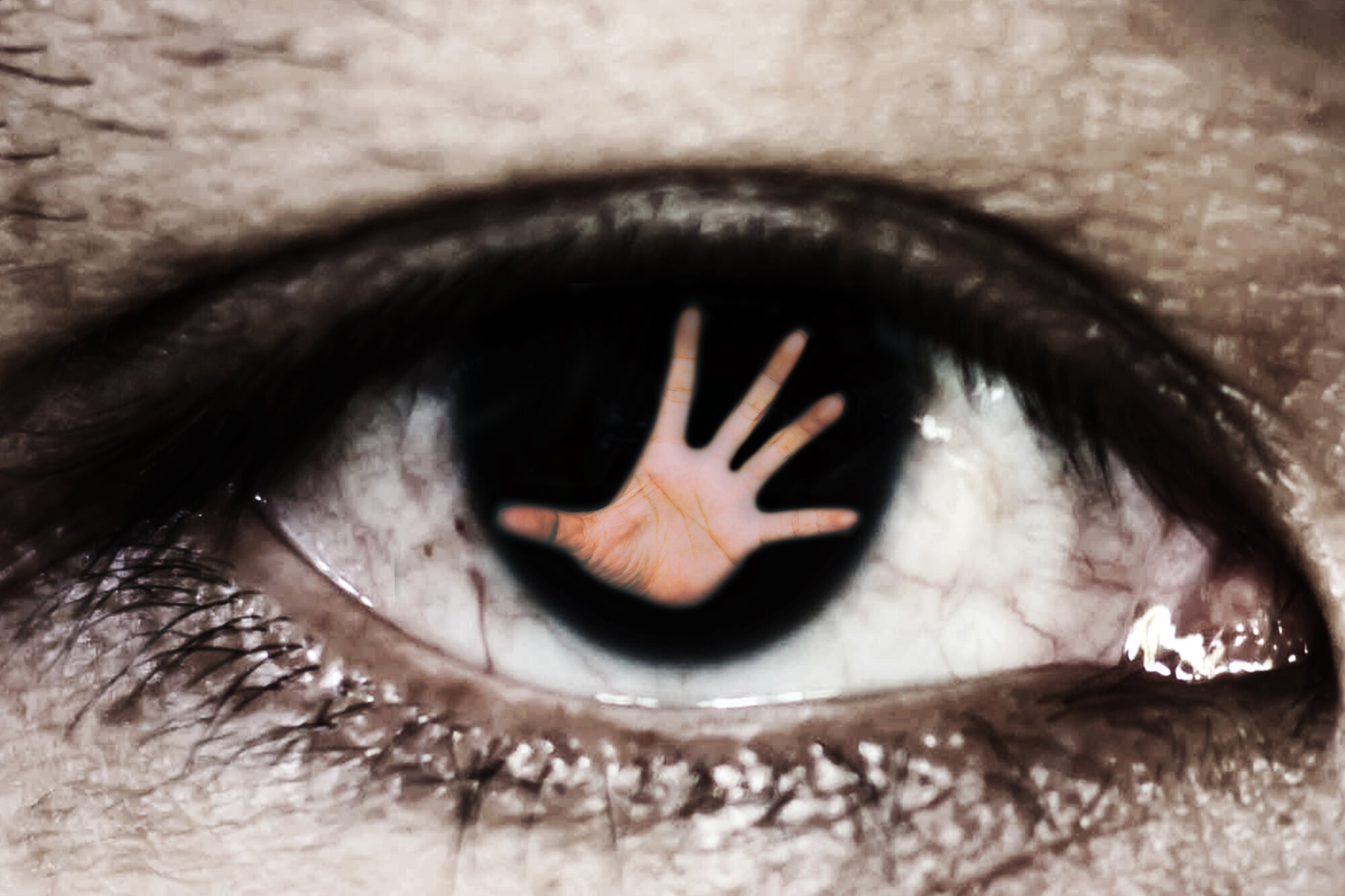 et øye med en hånd i pupillen bildet viser et øye med en hånd i pupillen