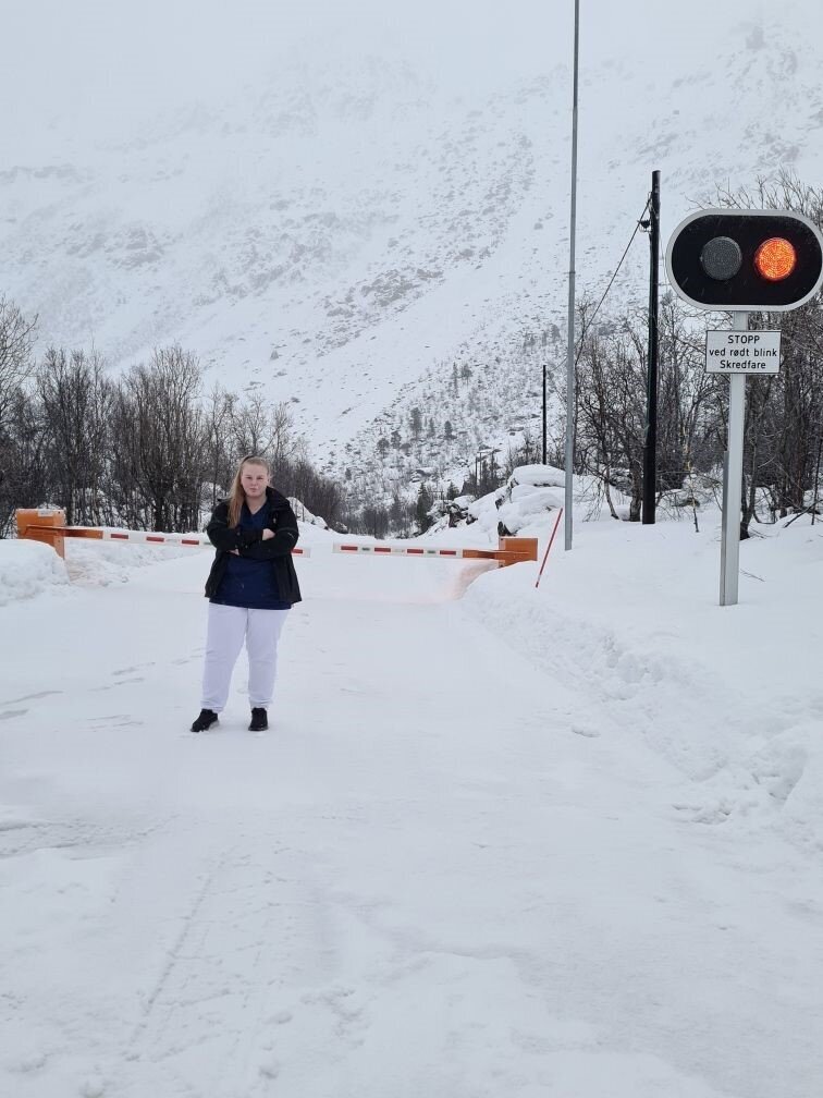 Bildet viser Henny Silkoset Hauan foran en stengt vei