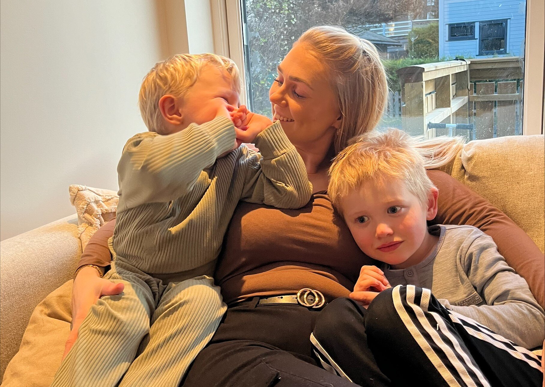 Bildet viser Erika Rosenvinge i sofaen sammen med sine to barn Bildet viser Erika Rosenvinge i sofaen sammen med sine to barn