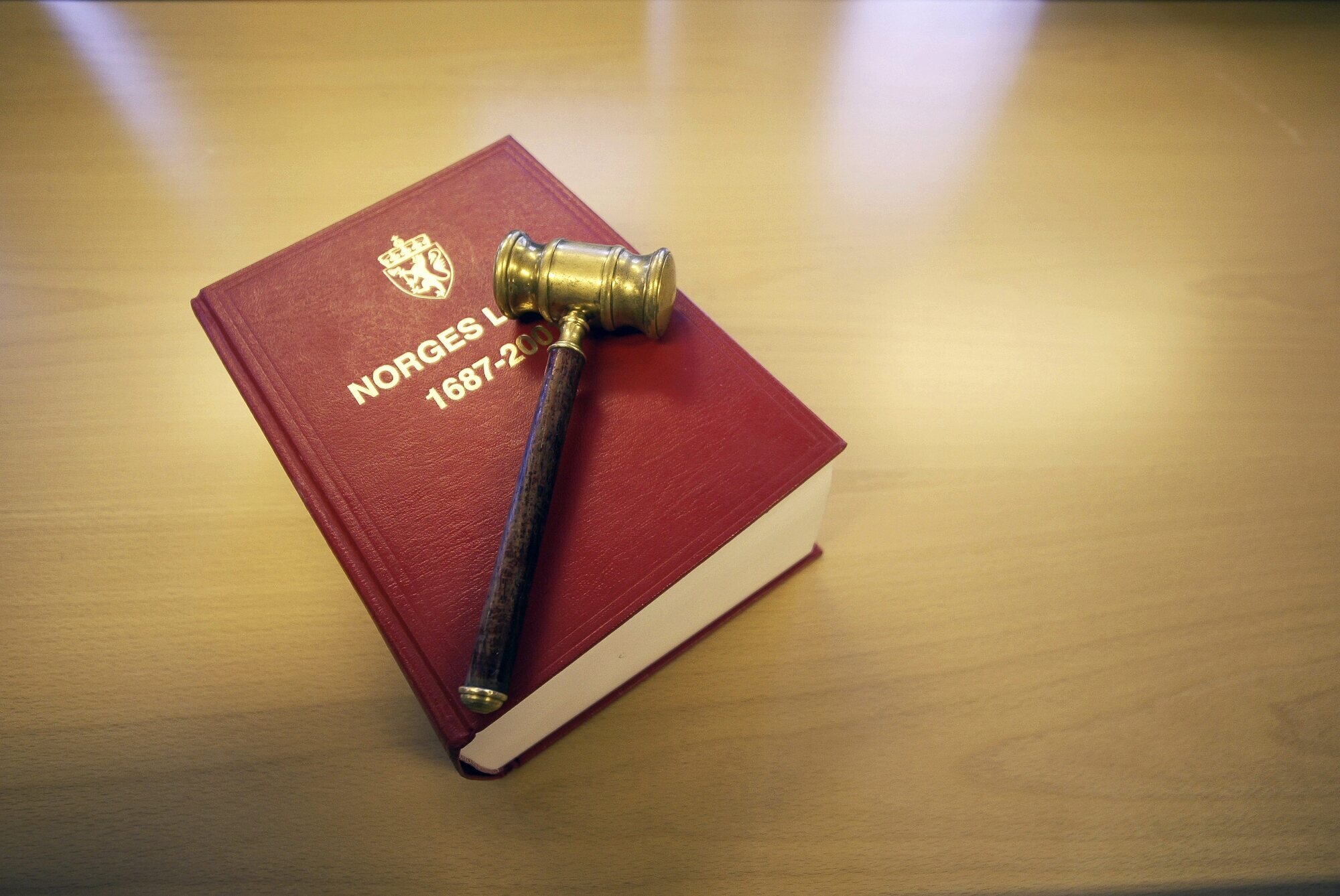 Bildet viser en klubbe som ligger oppå Norges lover