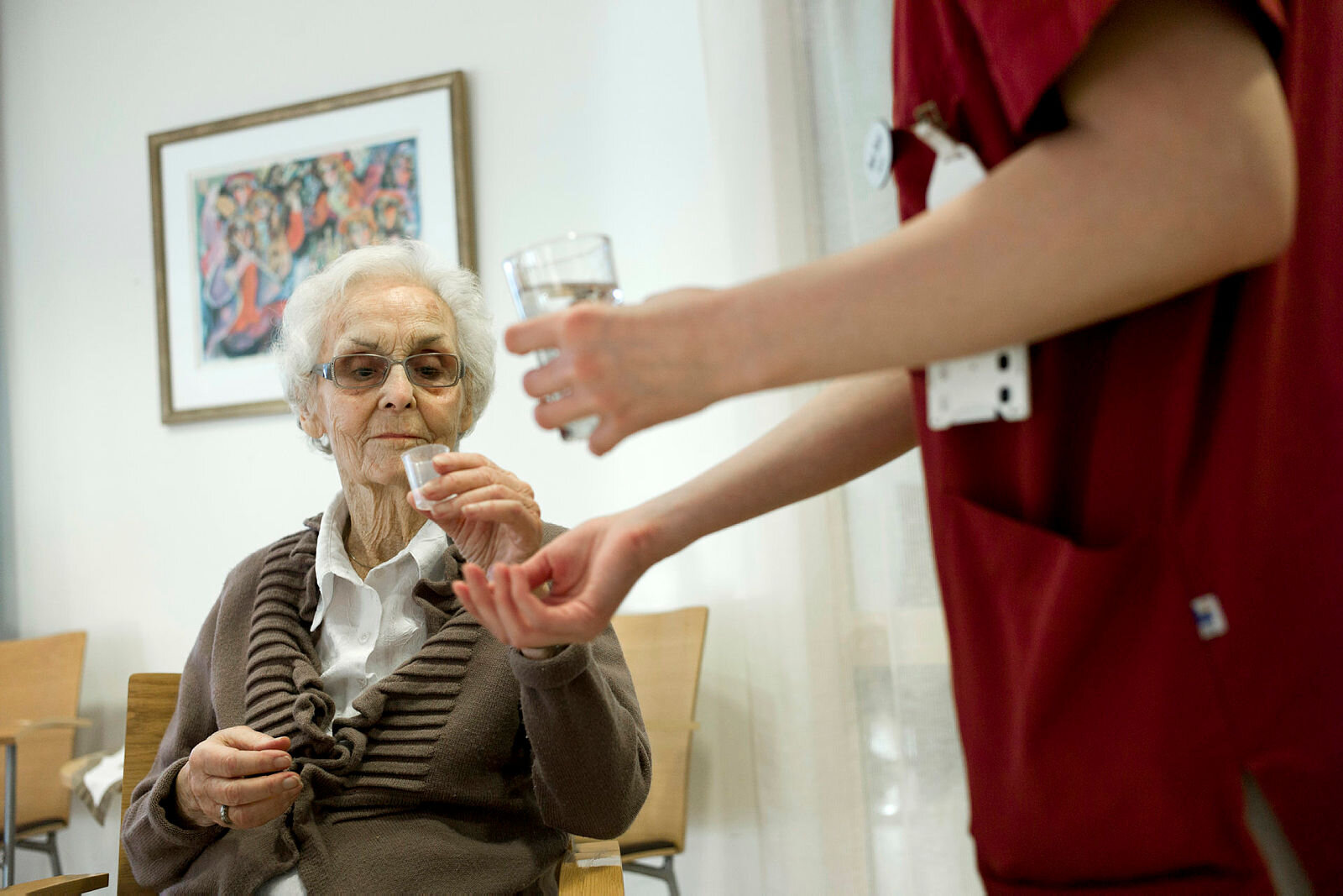 Eldre dame Bildet viser en eldre kvinne som får utdelt medisiner