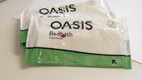 Bildet viser to pakker med vaskeklutene av typen Oasis Bedbath.