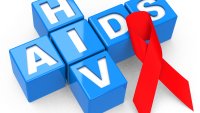 Verdens aidsdag, hiv, aids En rød sløyfe ligger oppå bokstavene til hiv/aids.