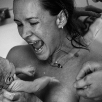 Bildet viser en fødsel i et badekar.